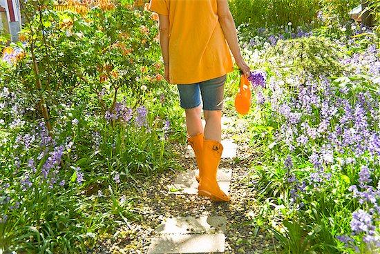 woman gardening backyard, orange boots