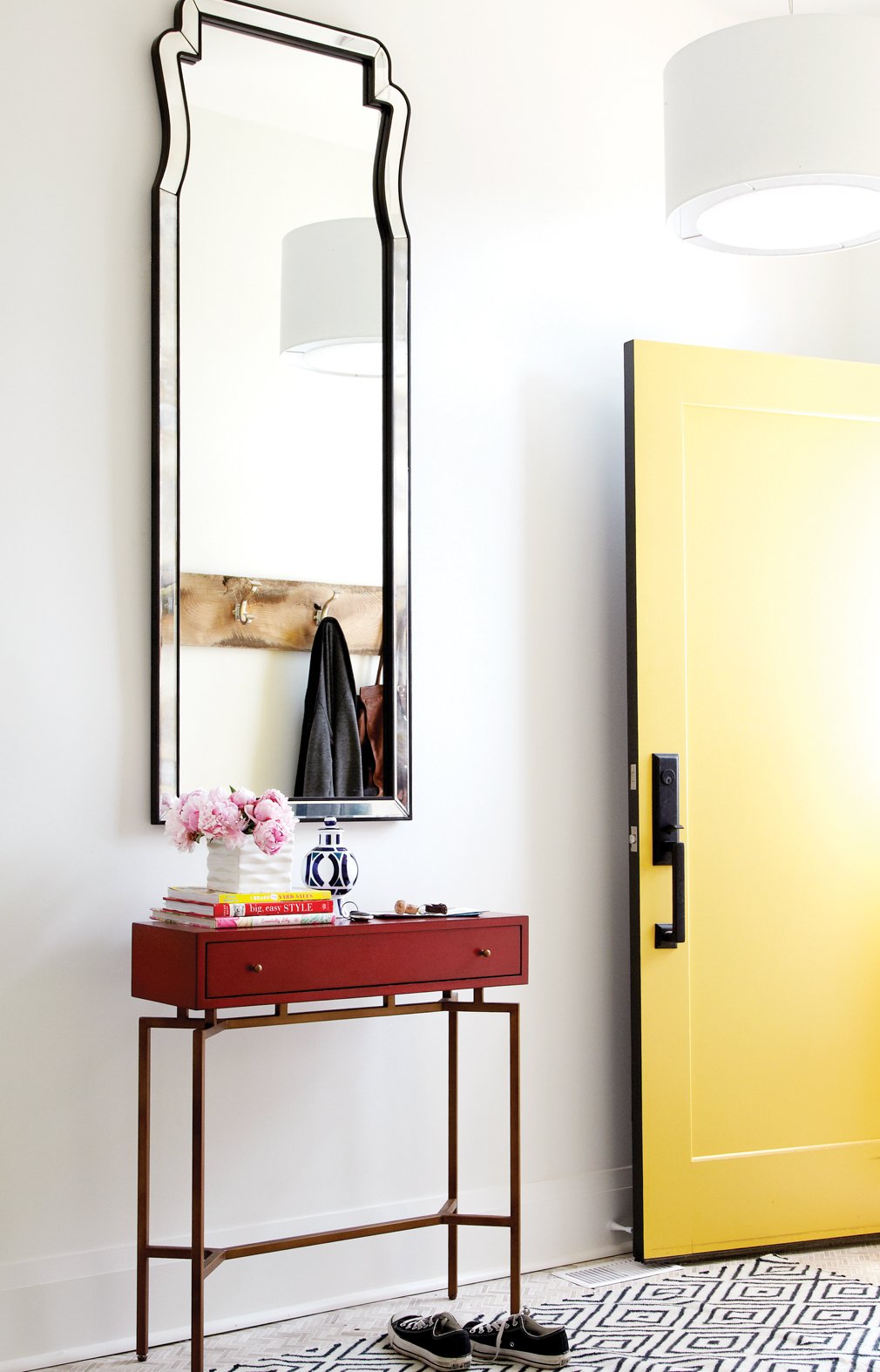 Hallway, tall mirror, small side table, yellow door