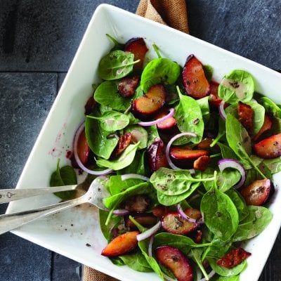 Roasted plum and spinach salad