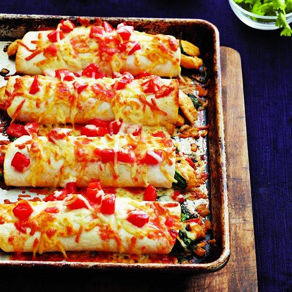 Chicken enchiladas recipe: Four chicken enchiladas on a roasting pan fresh from the oven