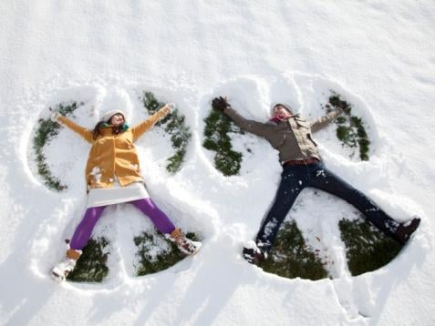 man and woman, couple making snow angels, winter