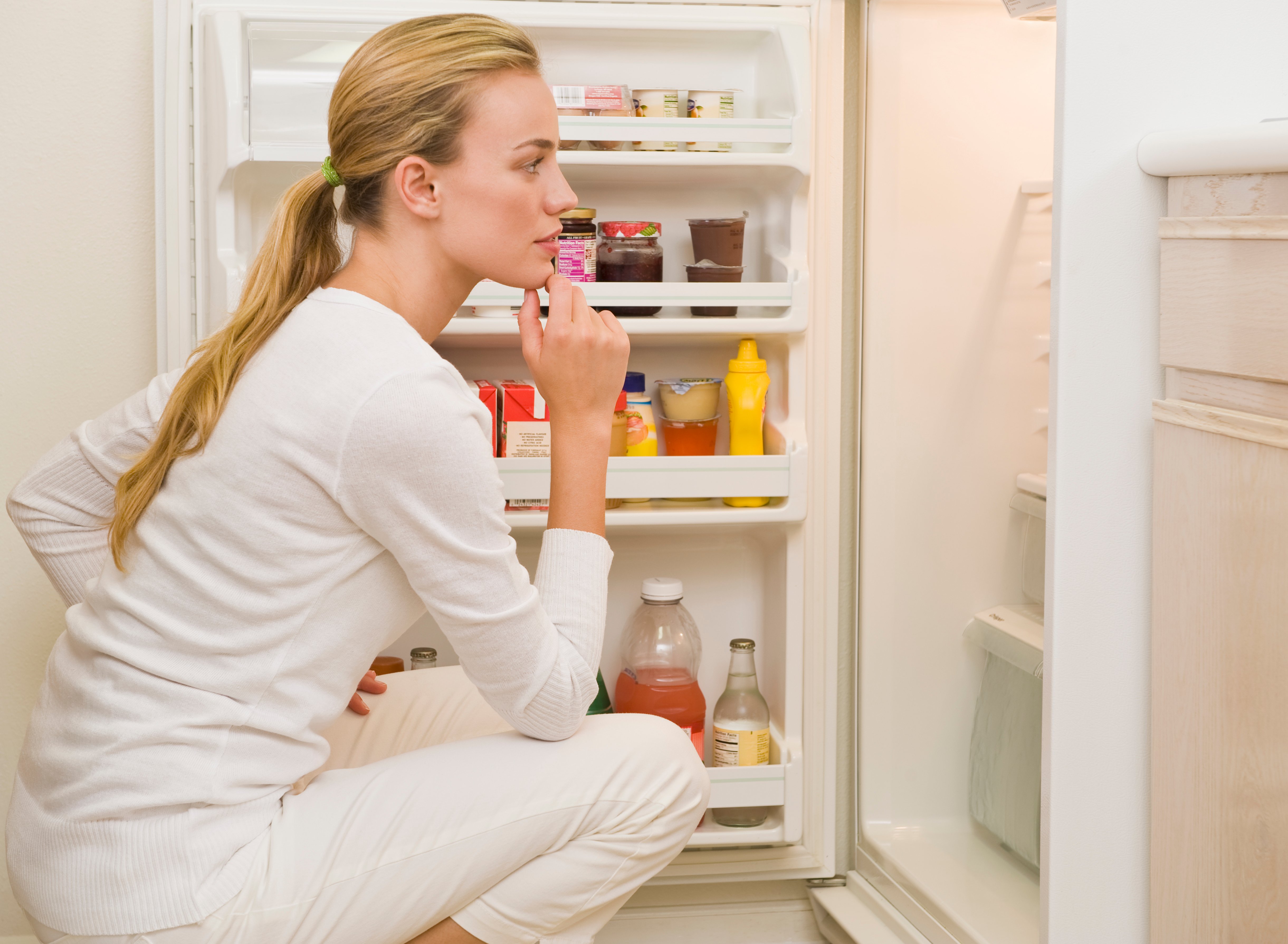woman looking in fridge, food