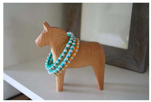 DIY turquoise pearl braclets on the neck of a Swedish horse