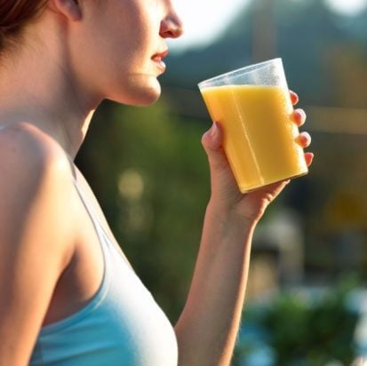 Woman drinking fresh orange juice