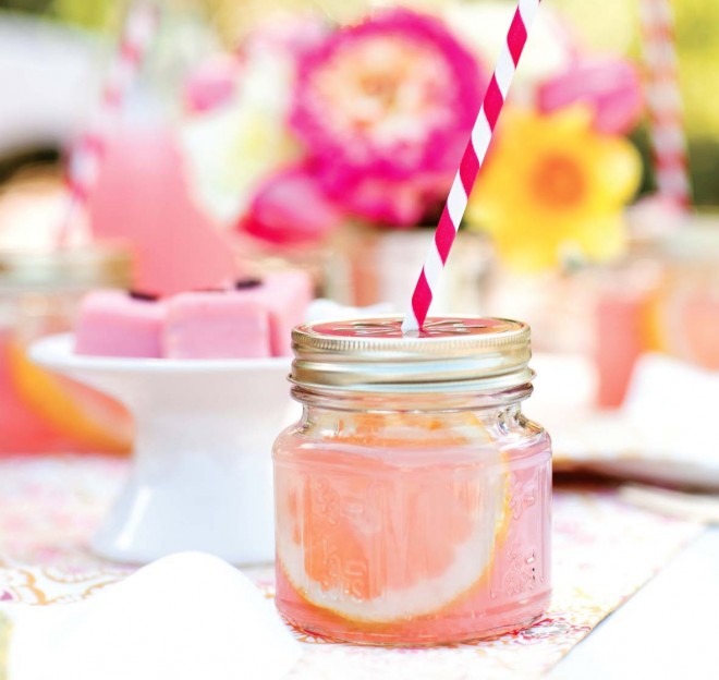 Jar filled with lemonade with striped straw