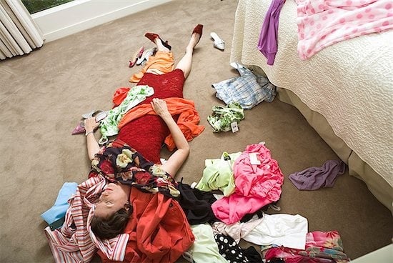 Woman surrounded by clothes