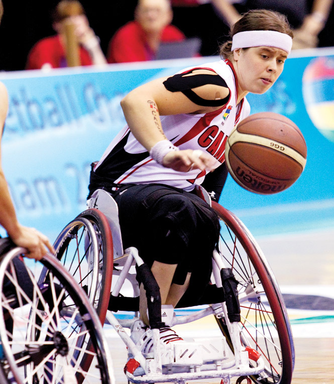 Cindy Ouellet in wheelchair playing basketball