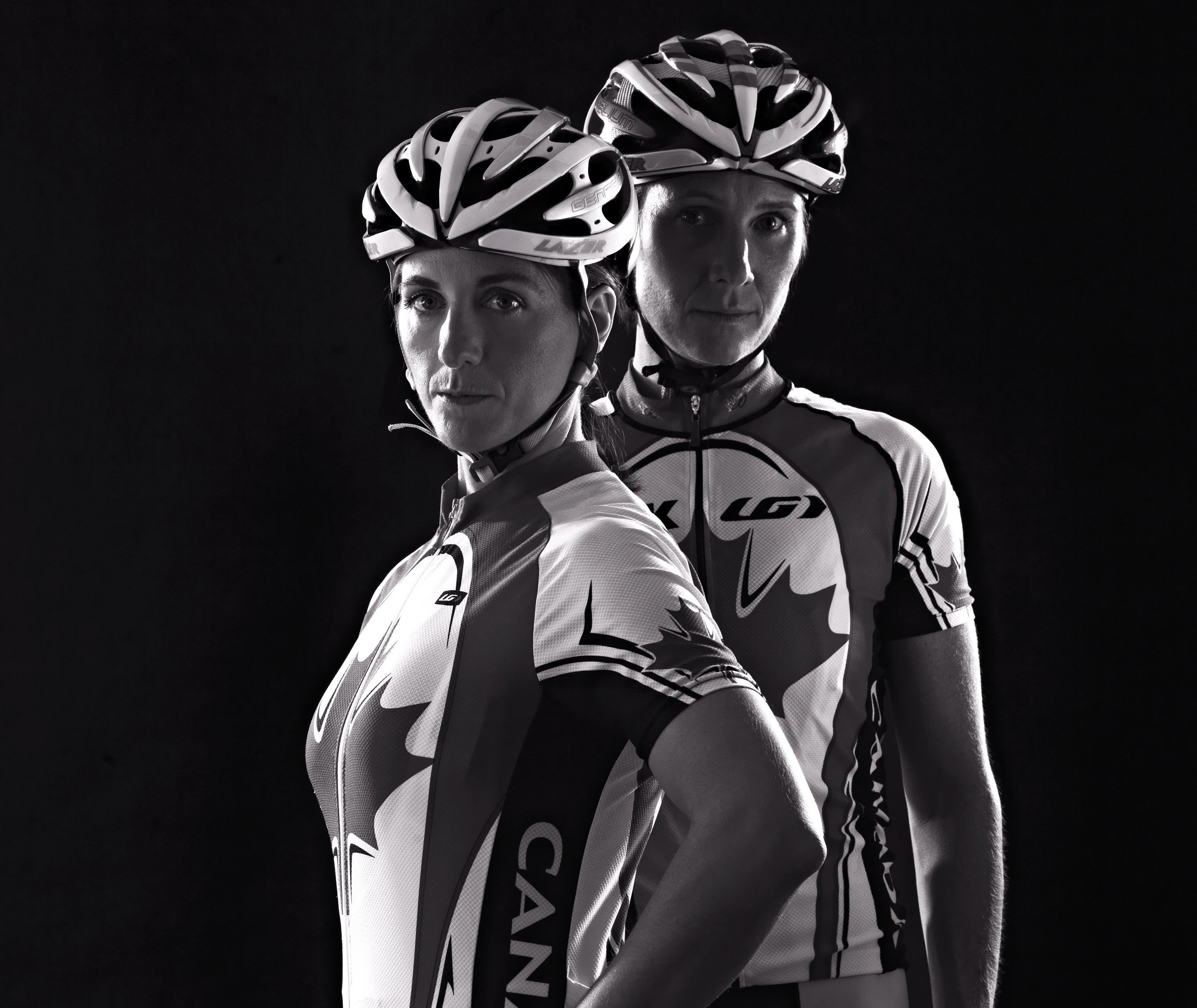 Robbi Weldon in cycling gear standing with tandem bike partner