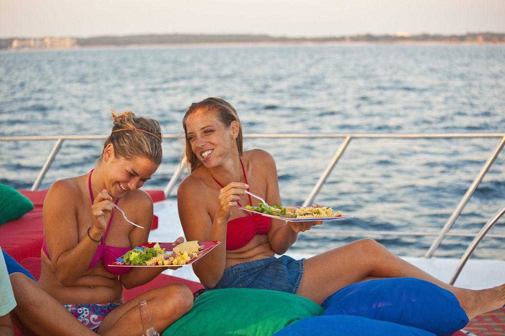 Women eating pasta on a boat