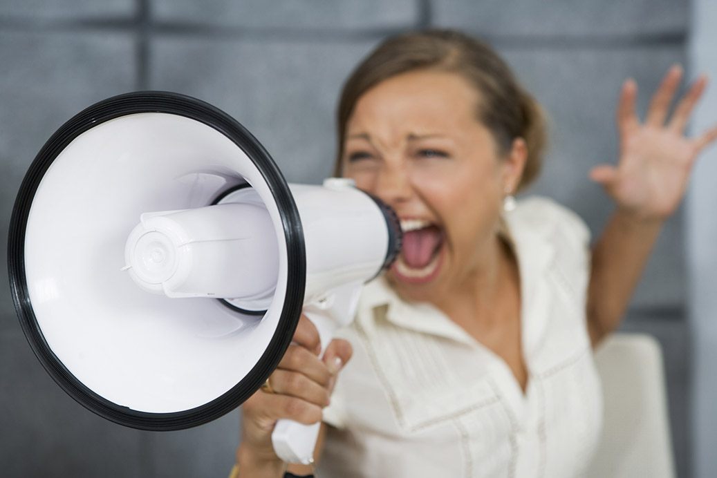 Woman yelling into a megaphone