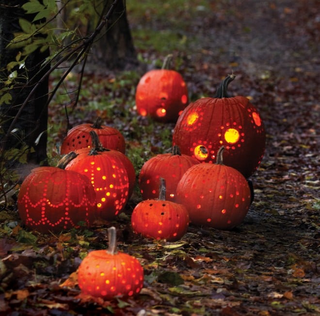 Jack-'o-lanterns on path, lit carved pumpkins