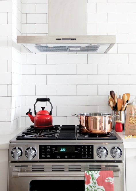 Kitchen, stove, tiled backsplash, red kettle, white subway tiles, black grout