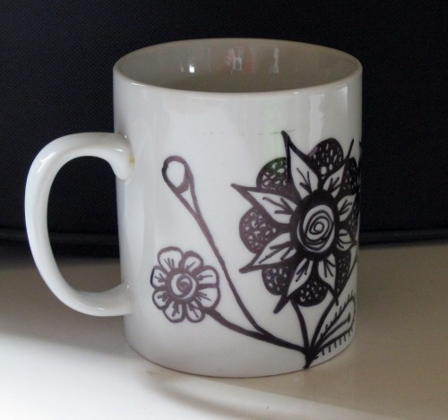 black and white floral mug with marker