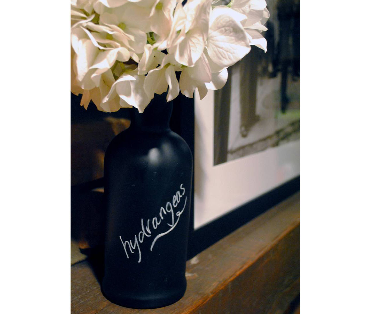 Chalkboard wine bottle vase with hydrangeas