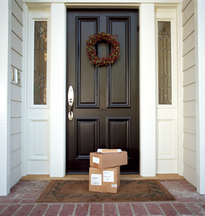 brown parcels on door step, Christmas gifts