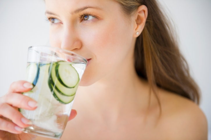 Woman Drinking Water with cucumber