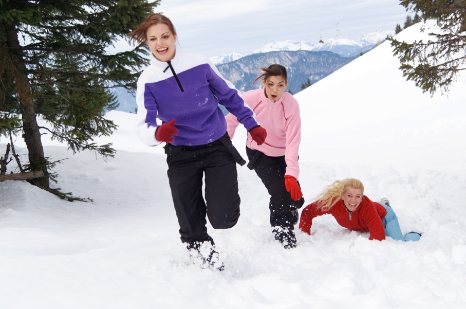 Three women running in the snow