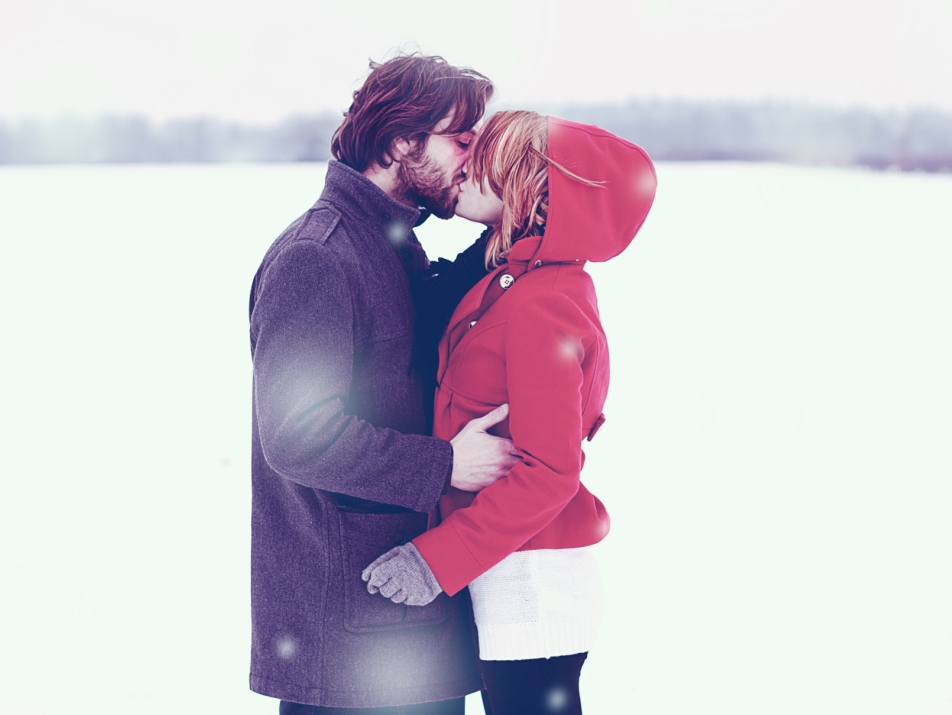Young couple kissing in the snow