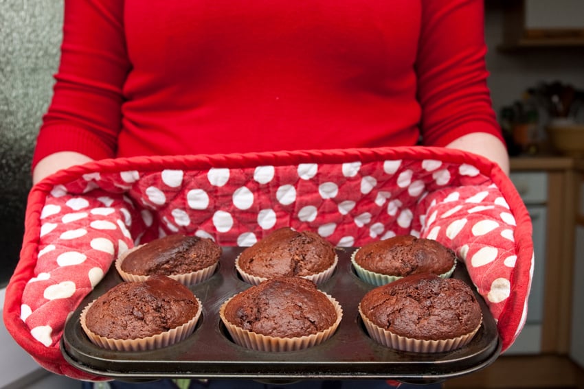 Woman giving muffins to guest