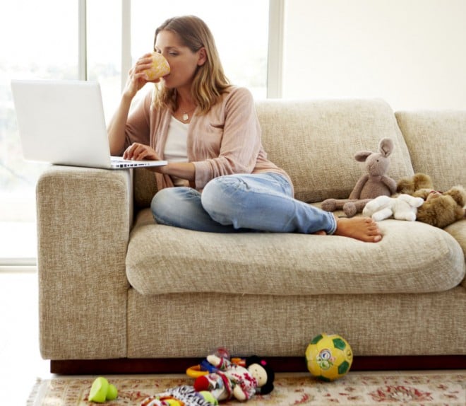 Woman sitting on her couch with laptop