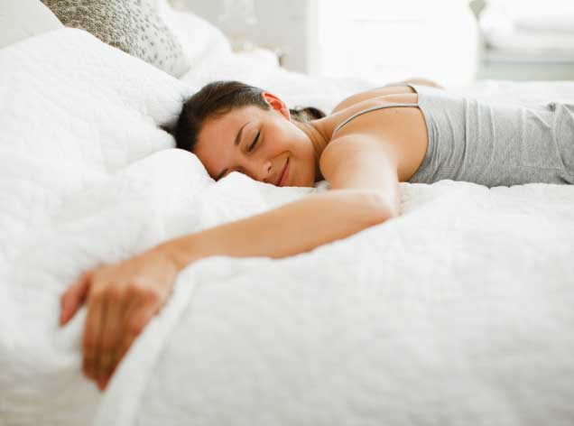 Happy Woman Sleeping in bed alone