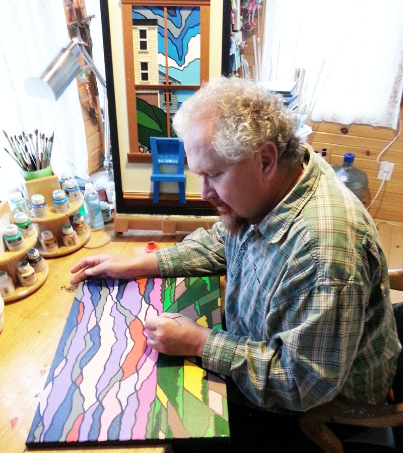 Bronson Smith paints in his studio