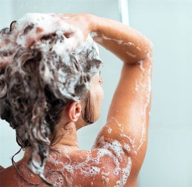 A woman washing her hair in the shower