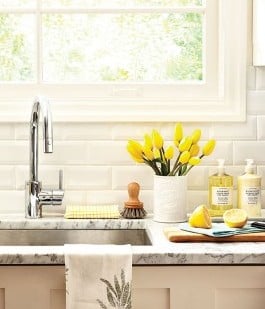clean organized kitchen counter spring yellow tulips sink window