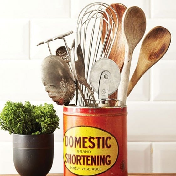 organizing your kitchen cupboards: use a tin can to store cooking utensils on your countertop