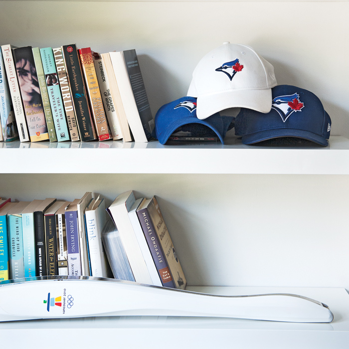 Evanka's favourite books, just a few of her many Blue Jays hats and the official Vancouver 2010 Olympic torch that she ran with. Photo, Sian Richards.