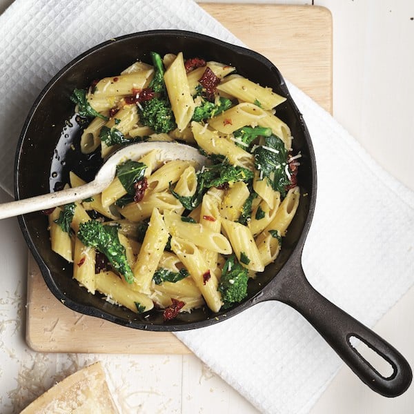 Sun-dried tomato pasta: Penne noodles with rapini and sun-dried tomatoes in a sauté pan