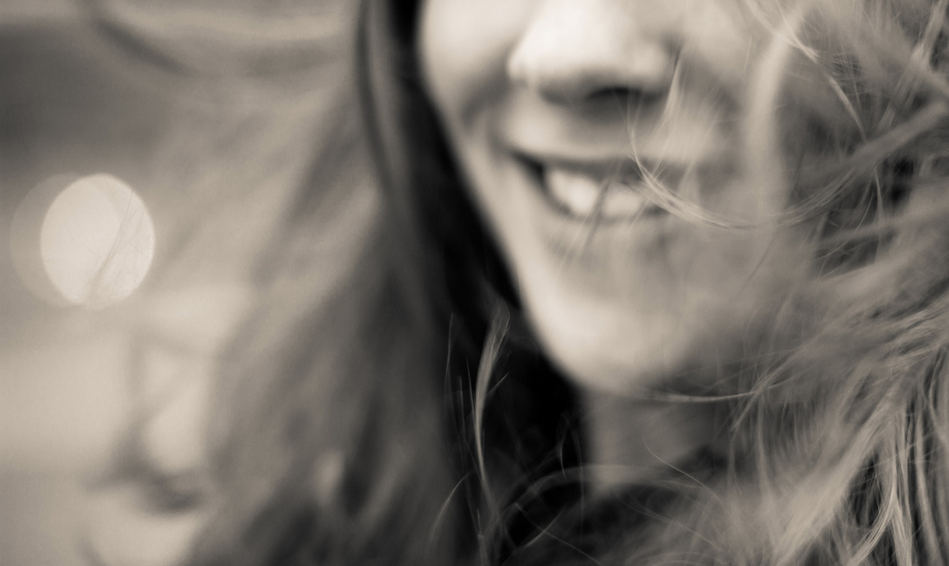 A happy woman smiling. Photo by Porsche Brosseau/Flickr via Creative Commons.