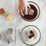 Dipping lamingtons into chocolate and coconut
