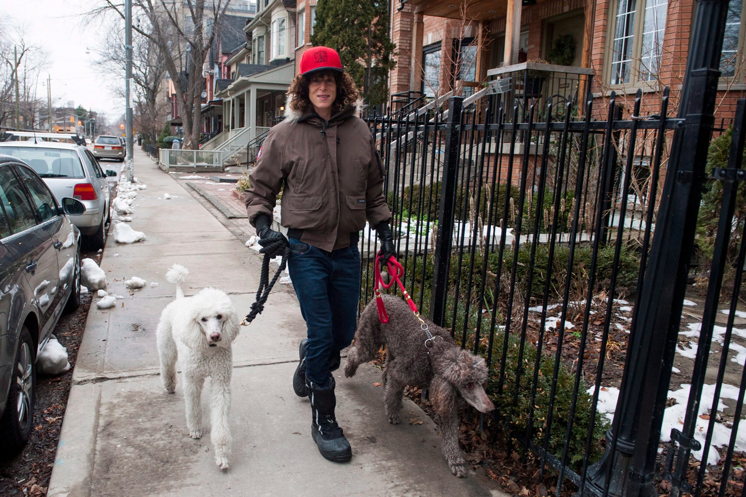 Andrea Constand, who has accused Bill Cosby of sexually assaulting her, walks her dogs in Toronto Thursday, Dec. 31, 2015.