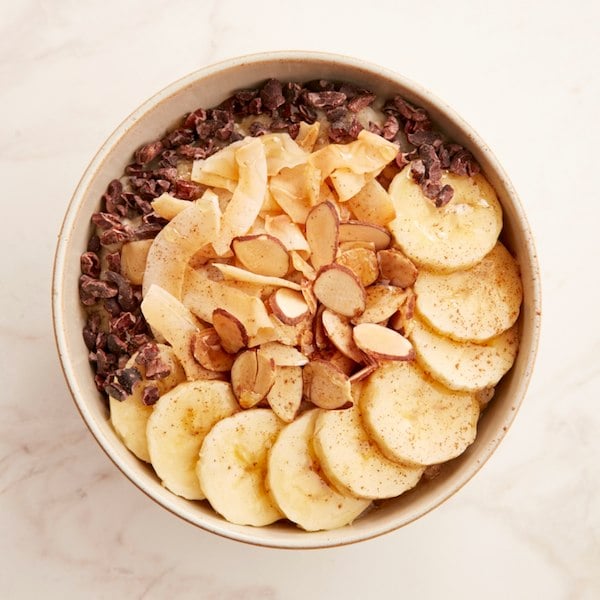 Chai oatmeal for breakfast with bananas cocoa nibs and roasted sliced almonds