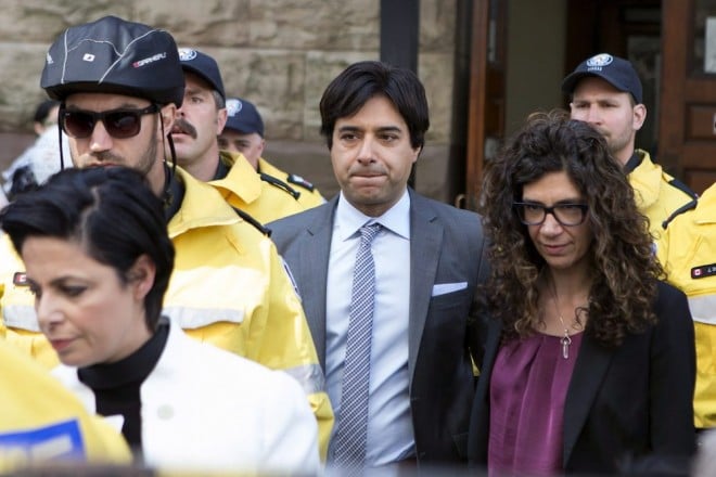 Former CBC radio host Jian Ghomeshi leaves a Toronto court with his sister Jila Ghomeshi, right, and lawyer Marie Henein, in foreground, after signing a peace bond, on Wednesday, May 11, 2016. THE CANADIAN PRESS/Chris Young