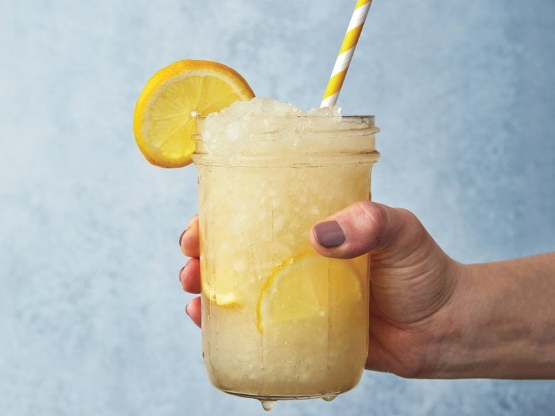 How to make lemonade: lemonade slushy being held out by hand