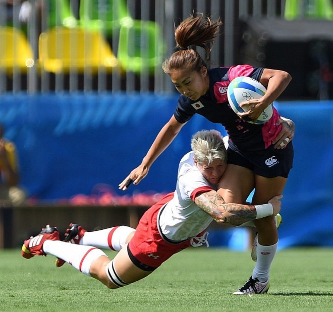 Canada's Jen Kish tackles Marie Yamaguchi of Japan during women's sevens rugby action at the 2016 Olympic Games in Rio de Janeiro, Brazil on Saturday, Aug. 6, 2016. THE CANADIAN PRESS/Sean Kilpatrick