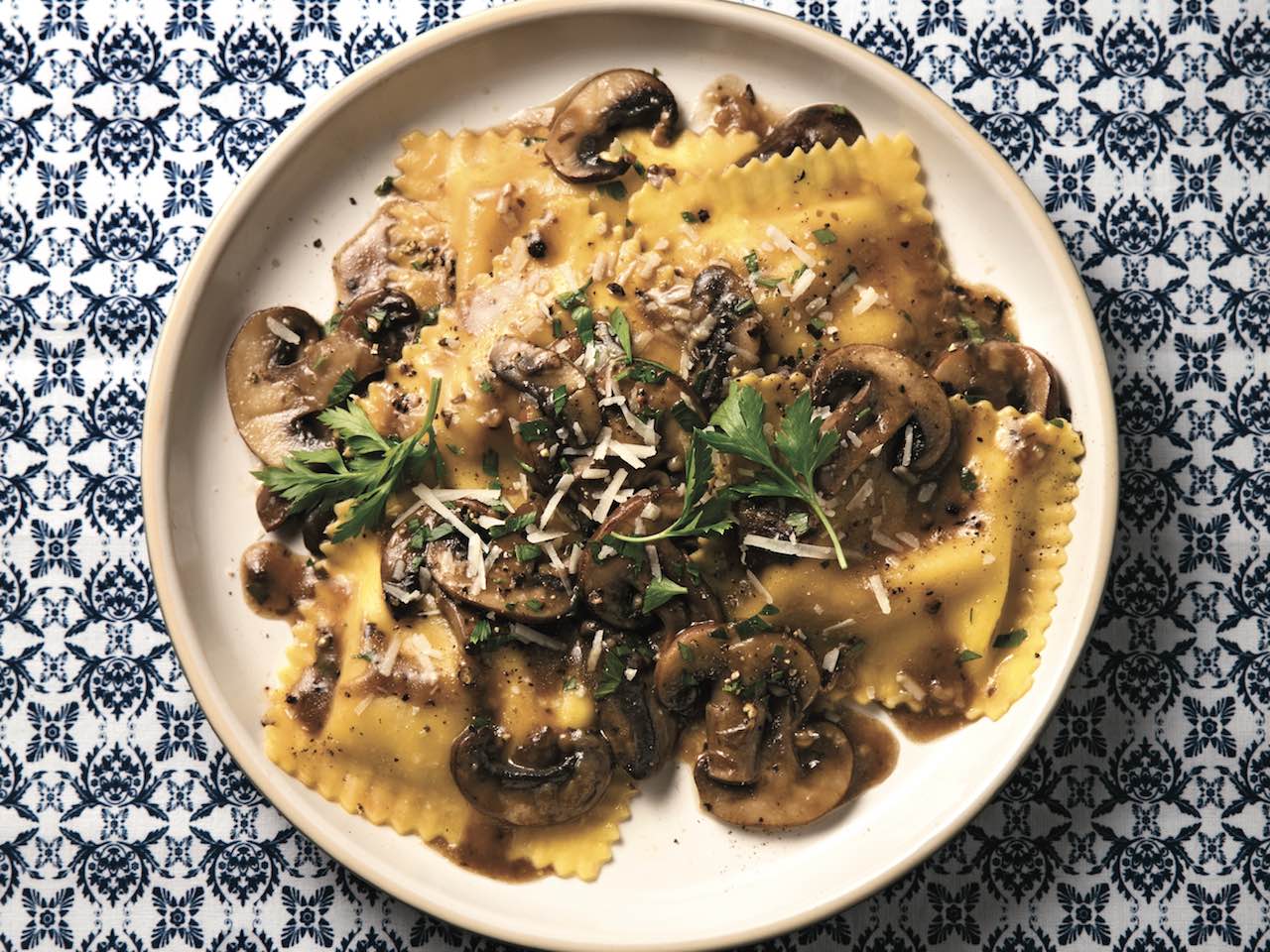 This cheesy ravioli pasta with earthy mushrooms and fresh parsley is ready ...