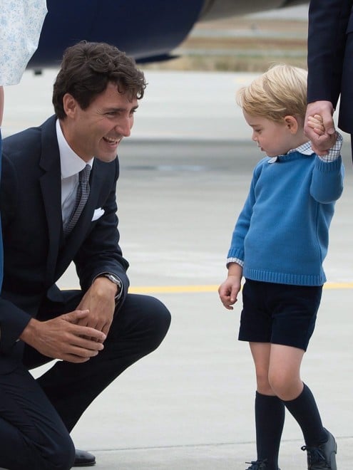 Prime Minister Justin Trudeau, centre, kneels to talk to Prince George as his father The Duke of Cambridge speaks with Governor General David Johnston, right, and The Duchess of Cambridge holds their daughter Princess Charlotte upon arrival in Victoria, B.C., on Saturday, September 24, 2016. THE CANADIAN PRESS/Jonathan Hayward