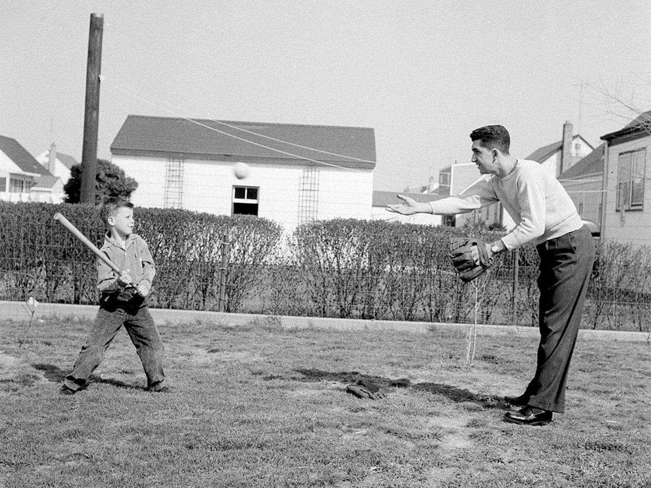 Vintage photo of dad and son playing catch