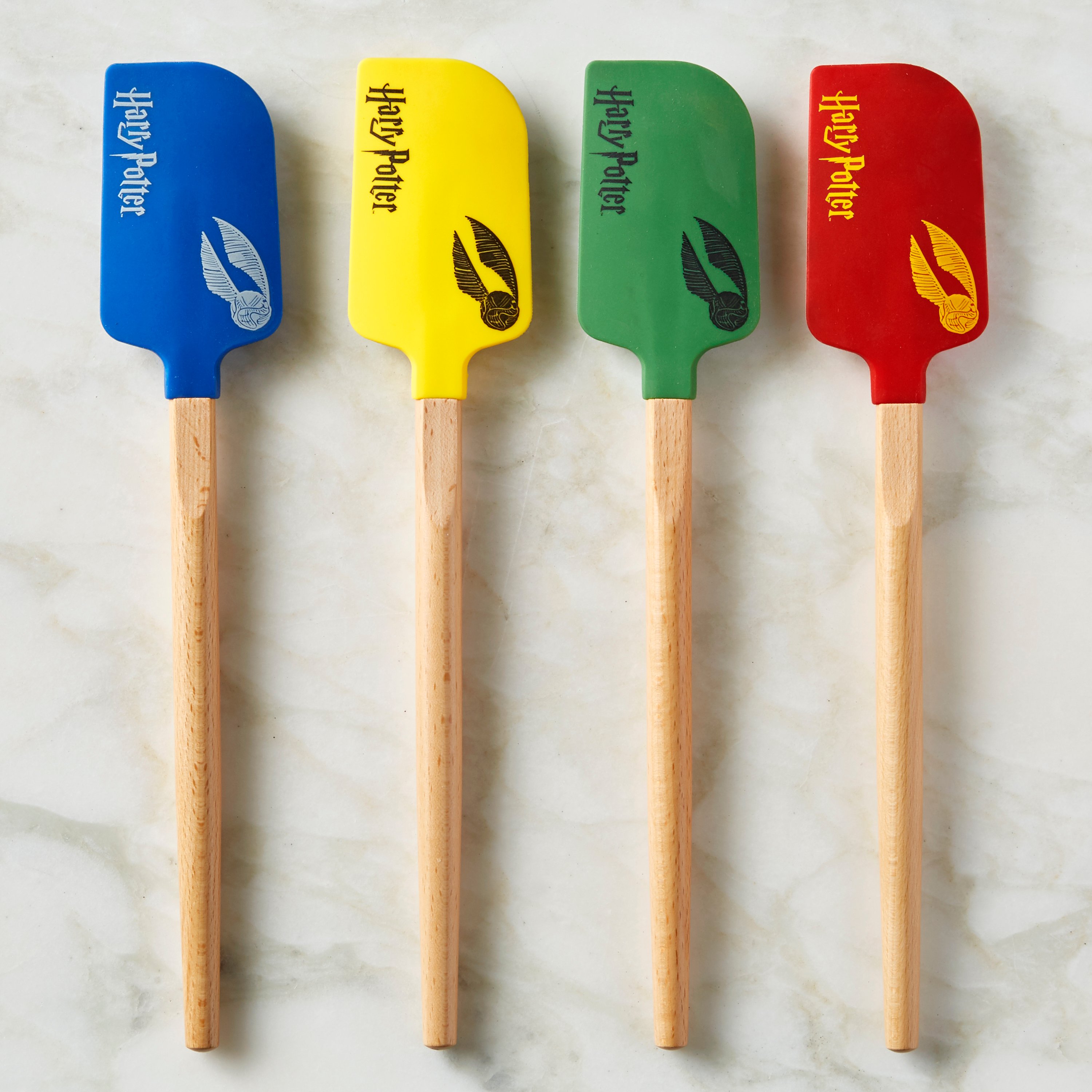 Blue, yellow, green and red spatula that say Harry Potter