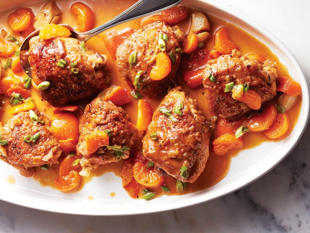 Braising, one of the best ways to cook meat. Shown: orange soy-braised chicken thighs on white platter