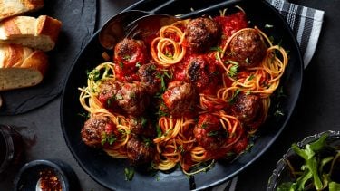 spaghetti and meatballs in serving bowl