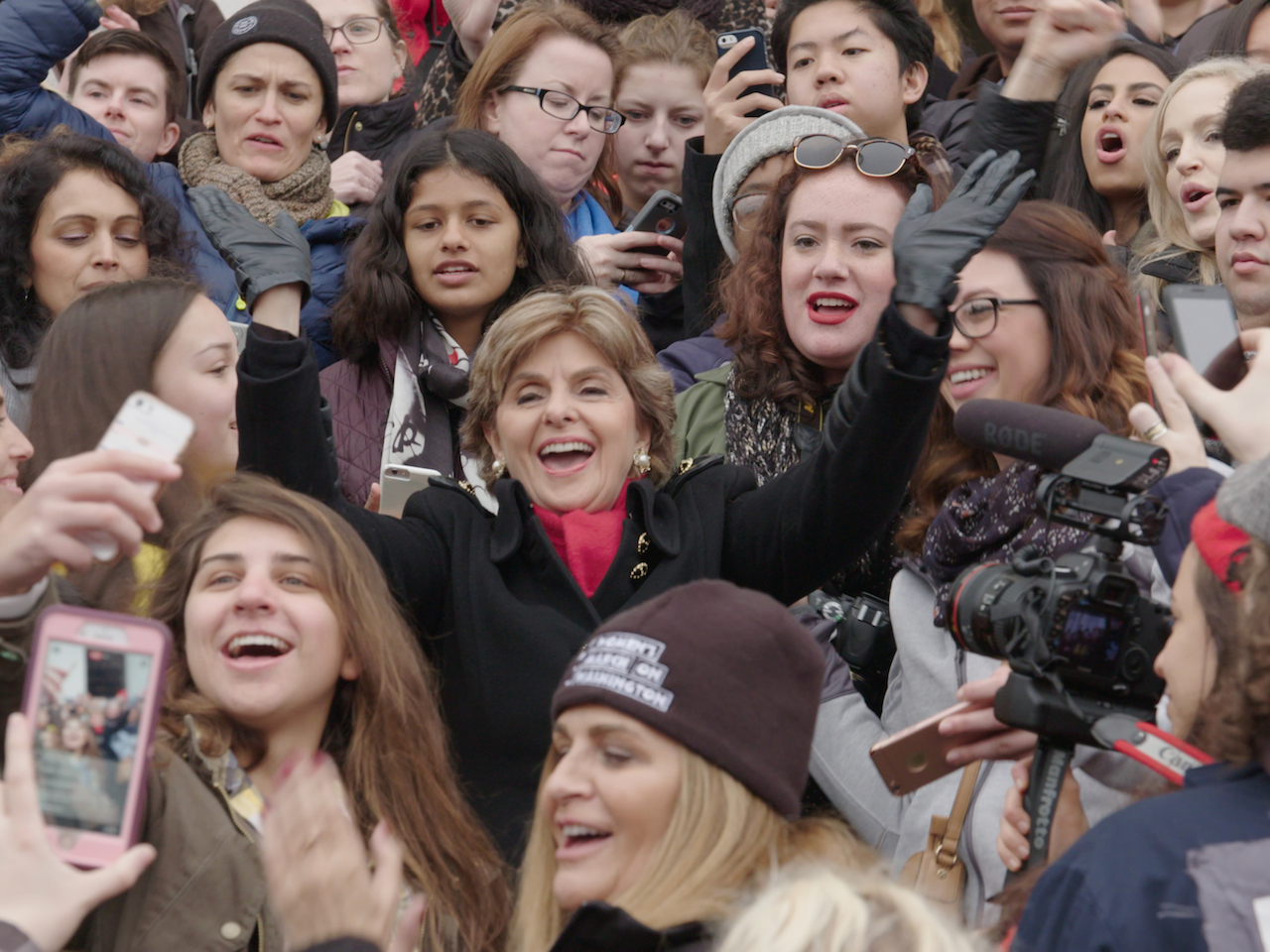 Netflix February-SEEING ALLRED movie still of Allred surrounded by young women. Documentary on Netflix February 2018