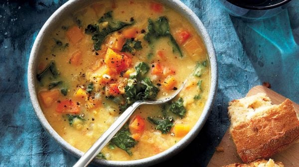 coconut-miso, squash and red lentil soup in bowl with spoon