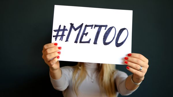 metoo in the workplace: young women holds #metoo sign