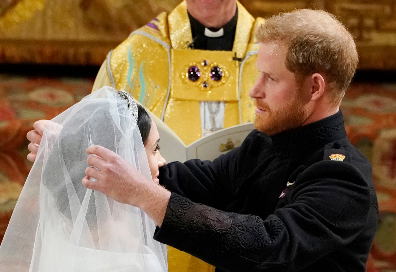 Prince Harry lifts the veil of Meghan Markle during their royal wedding