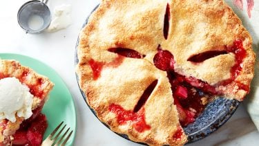 strawberry rhubarb pie with a slice missing