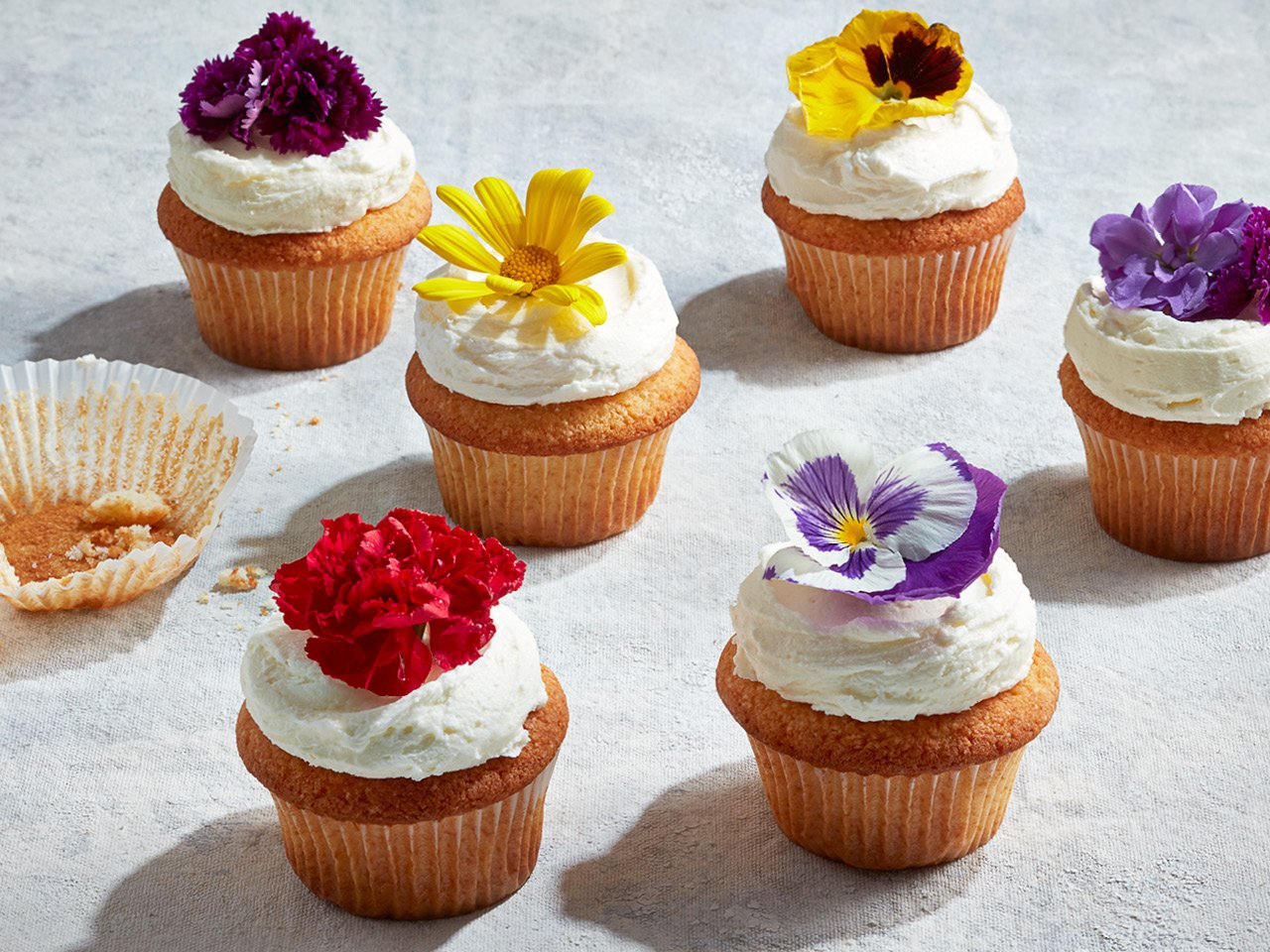 Lemon elderflower cupcakes topped with icing and flowers